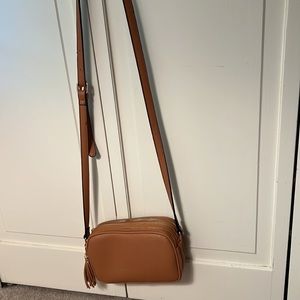 Gorgeous tan pebbled crossbody bag with animal print detail inside